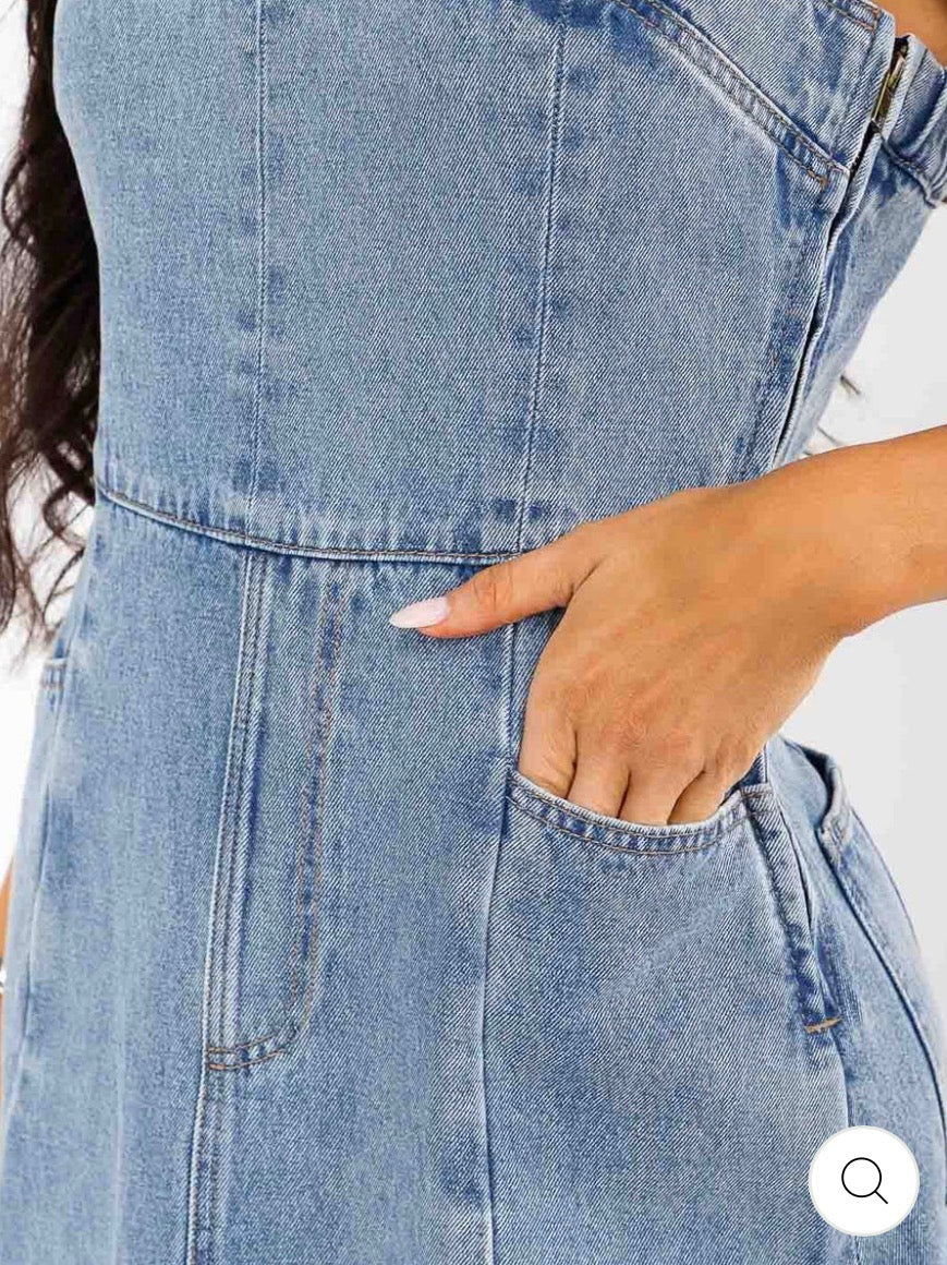 Vestido maxi azul de denim lavado para mujer, sin mangas y con bolsillos frontales.