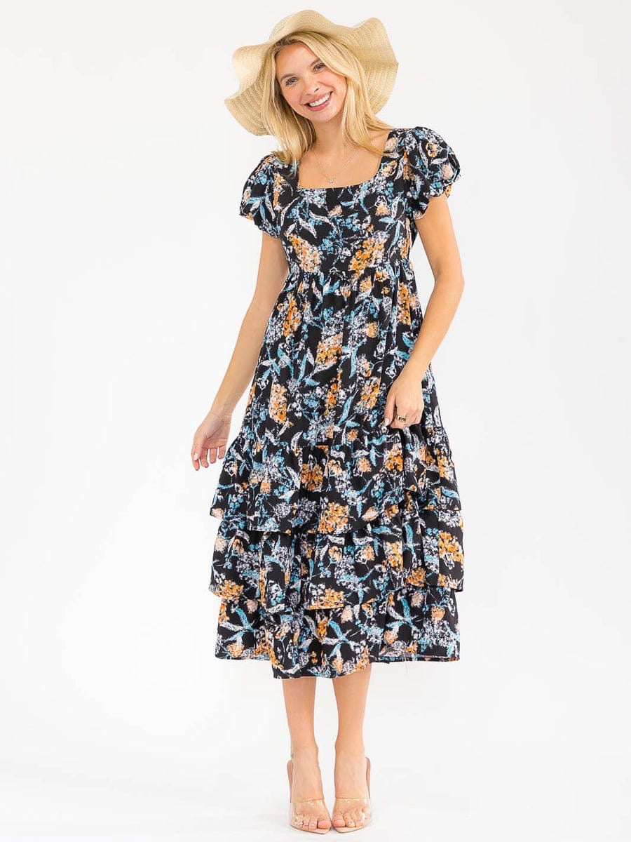 Vestido negro floral de vuelos