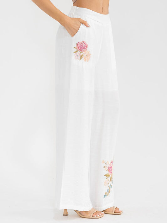 Pantalón blanco palazzo de pierna ancha con bordado floral