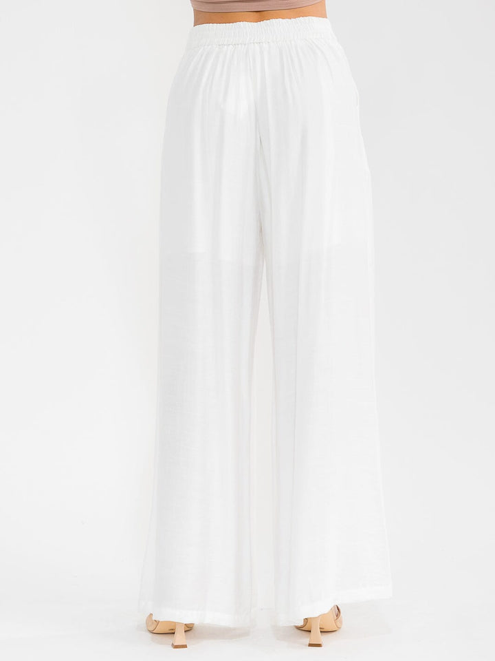 Pantalón blanco palazzo de pierna ancha con bordado floral